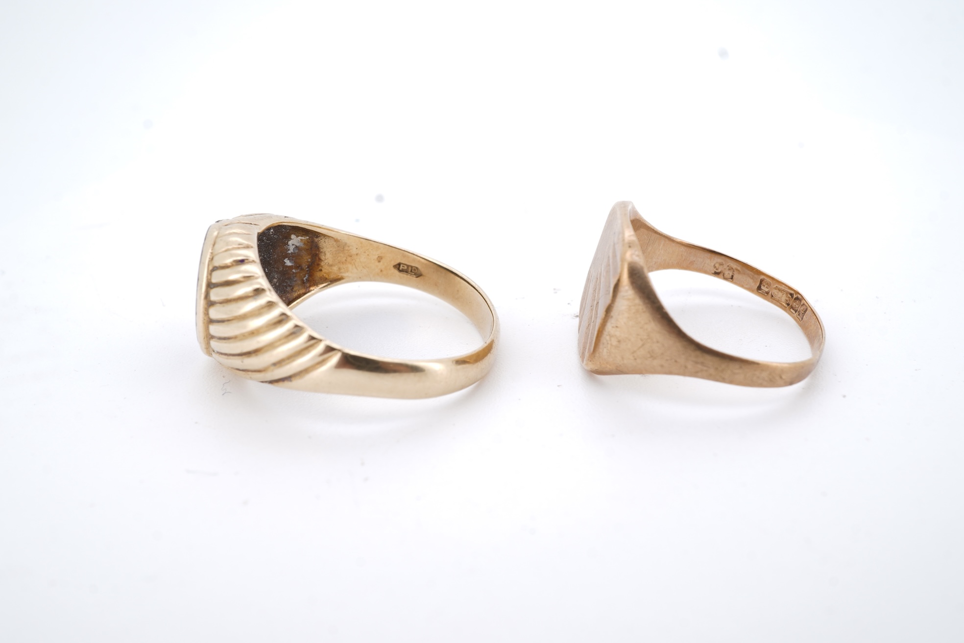 A 1960's 9ct gold and black onyx set signet ring, size X, one other 9ct gold signet ring, a 9ct gold dress stud, a 9ct gold pendant mount and two damaged 9k necklaces, gross weight 21 grams.